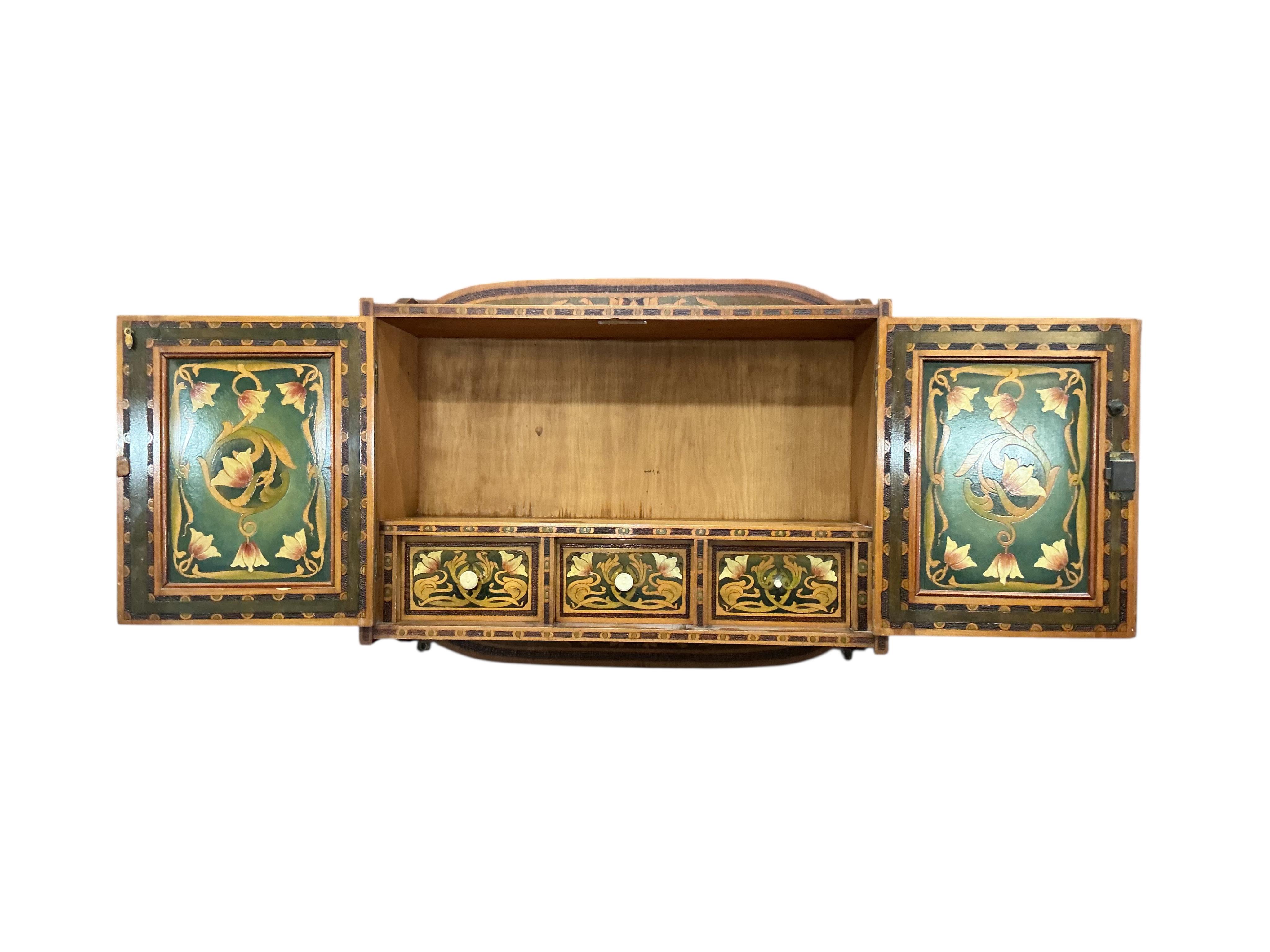 An Art Nouveau poker work two door wall cabinet, width 61cm, depth 21cm, height 52cm